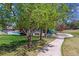 A view of a neighborhood park including a playground and a swimming pool surrounded by green grass and trees at 5320 S Geneva St, Englewood, CO 80111