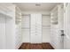 Spacious walk-in closet with custom built-in shelving and drawers for ample storage at 5320 S Geneva St, Englewood, CO 80111