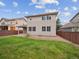 Backyard with green grass, stone mulch, and view of the home's exterior at 15350 W 50Th Dr, Golden, CO 80403