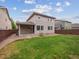 Backyard with green grass, stone mulch, patio, and view of the home's exterior at 15350 W 50Th Dr, Golden, CO 80403