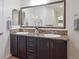 Bathroom featuring a double sink vanity, modern fixtures, and a large mirror, providing a functional space at 15350 W 50Th Dr, Golden, CO 80403