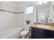 Bathroom featuring white tiling, accent mosaic, dark cabinets, and toilet at 15350 W 50Th Dr, Golden, CO 80403