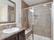Bathroom featuring a tiled shower with a glass door, a bench, and a decorative mosaic accent at 15350 W 50Th Dr, Golden, CO 80403