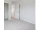 An empty bedroom with carpet, closet, and a door leading into the hallway at 15350 W 50Th Dr, Golden, CO 80403