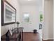 Bright entryway featuring hardwood floors, a console table with decor, and a white front door at 15350 W 50Th Dr, Golden, CO 80403