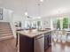 Open floor plan featuring a kitchen island adjacent to the living and dining areas at 15350 W 50Th Dr, Golden, CO 80403