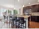 Open kitchen features a large island with bar seating, stainless steel appliances, and dark cabinetry at 15350 W 50Th Dr, Golden, CO 80403