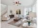 Bright living room showcases an open floor plan, neutral color palette, modern decor, and stairwell access at 15350 W 50Th Dr, Golden, CO 80403