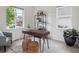Cozy home office with a wooden desk, decorative shelves, and natural light from two windows at 15350 W 50Th Dr, Golden, CO 80403