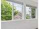 A view from inside looking out of a window at houses and foliage at 15350 W 50Th Dr, Golden, CO 80403