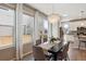 Bright dining room featuring a modern chandelier, table for six, and sliding doors to the patio at 11119 E 25Th Dr, Aurora, CO 80010