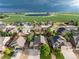 Overhead shot of neighborhood featuring single-Gathering homes with well-manicured lawns and a nearby pond at 2746 Stallion Way, Mead, CO 80542