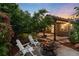 Relaxing backyard with fire pit, Adirondack chairs, and covered patio area at 2746 Stallion Way, Mead, CO 80542