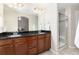 Bathroom boasts double sinks, granite countertops, and a glass-enclosed shower at 2746 Stallion Way, Mead, CO 80542
