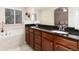 Bathroom features a double vanity, granite countertops, and a separate tub at 2746 Stallion Way, Mead, CO 80542