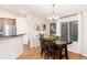 Inviting dining area with hardwood floors, chandelier, and bright natural light at 2746 Stallion Way, Mead, CO 80542