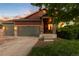 Charming home exterior featuring a two-car garage, stone accents, and a cozy front porch at 2746 Stallion Way, Mead, CO 80542