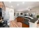 Spacious kitchen with stainless steel appliances, dark countertops, and hardwood floors at 2746 Stallion Way, Mead, CO 80542
