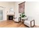 Inviting living area with a stone fireplace, hardwood floors, and comfortable armchairs at 2746 Stallion Way, Mead, CO 80542