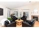 Bright living room featuring a fireplace, hardwood floors, and plenty of natural light at 2746 Stallion Way, Mead, CO 80542