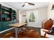 Inviting office space with custom teal cabinetry, light wood desk, and natural light at 2746 Stallion Way, Mead, CO 80542