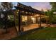 Inviting covered patio with string lights, perfect for outdoor dining and entertaining at 2746 Stallion Way, Mead, CO 80542