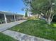 Spacious backyard with large shade tree and covered patio at 6552 S Pearl St, Centennial, CO 80121