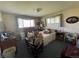 Bedroom with a bed, wheelchair, and multiple windows for natural light at 6552 S Pearl St, Centennial, CO 80121