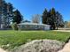 Charming single-story home with a well-maintained lawn, lovely trees, and an attached one-car garage at 6552 S Pearl St, Centennial, CO 80121