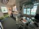 Bright eat-in kitchen boasts white cabinets, an adjacent table, and natural light at 6552 S Pearl St, Centennial, CO 80121