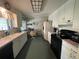 Bright eat-in kitchen with white cabinets, modern appliances, and natural light at 6552 S Pearl St, Centennial, CO 80121