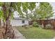 Private backyard featuring a patio seating area and a lush green lawn at 4001 Kalamath St, Denver, CO 80211