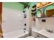 Renovated bathroom with modern black fixtures, and white tiled walls and tub at 4001 Kalamath St, Denver, CO 80211