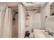 Functional bathroom featuring a shower, sink, and toilet with white tile throughout at 4001 Kalamath St, Denver, CO 80211