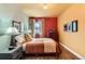 A well-lit bedroom features hardwood floors, a patterned comforter, art, and curtains at 4001 Kalamath St, Denver, CO 80211