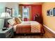 Inviting bedroom featuring hardwood floors, bright colors, and natural light from the window at 4001 Kalamath St, Denver, CO 80211