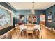 Dining room with dark blue walls, hardwood floors and decorative stained glass window at 4001 Kalamath St, Denver, CO 80211
