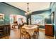 Dining area with wood floors and stained glass window open to the living room at 4001 Kalamath St, Denver, CO 80211