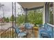 Front porch with ornate railing, seating, and vibrant plants creating a welcoming entrance at 4001 Kalamath St, Denver, CO 80211