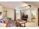Cozy living room featuring a comfortable sofa, television, and open doorway to the kitchen at 4001 Kalamath St, Denver, CO 80211
