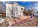 Brick patio, deck, pergola, and mature trees create a relaxing backyard oasis at 9318 W Coal Mine Ave, Littleton, CO 80123