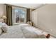 Main bedroom with plush bed and view from large window at 9318 W Coal Mine Ave, Littleton, CO 80123