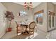 Charming dining room with stained glass window and wooden table at 9318 W Coal Mine Ave, Littleton, CO 80123