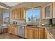 Kitchen with light wood cabinets, granite countertops and stainless steel appliances at 9318 W Coal Mine Ave, Littleton, CO 80123