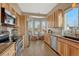 Eat-in kitchen with light wood cabinets, granite counters, and stainless steel appliances at 9318 W Coal Mine Ave, Littleton, CO 80123