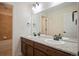 Bathroom featuring double sink vanity with granite countertop and tiled floors at 6276 S Robertsdale Ct, Aurora, CO 80016