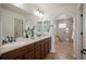 Spacious bathroom featuring double sinks, a large mirror, and a glass-enclosed shower at 6276 S Robertsdale Ct, Aurora, CO 80016