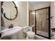 Stylish bathroom features a glass shower, decorative mirror, and modern fixtures at 6276 S Robertsdale Ct, Aurora, CO 80016
