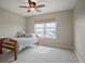 Bright bedroom with a cozy bed, neutral paint, a large window, and ceiling fan at 6276 S Robertsdale Ct, Aurora, CO 80016