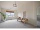 Serene bedroom with high ceilings, large window, and seating area with two chairs at 6276 S Robertsdale Ct, Aurora, CO 80016